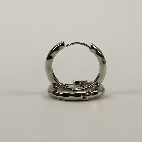 Pair of polished silver hoop earrings on a light grey background.