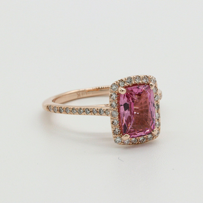 Second angle of the same pink-stone rose-gold halo ring on white.